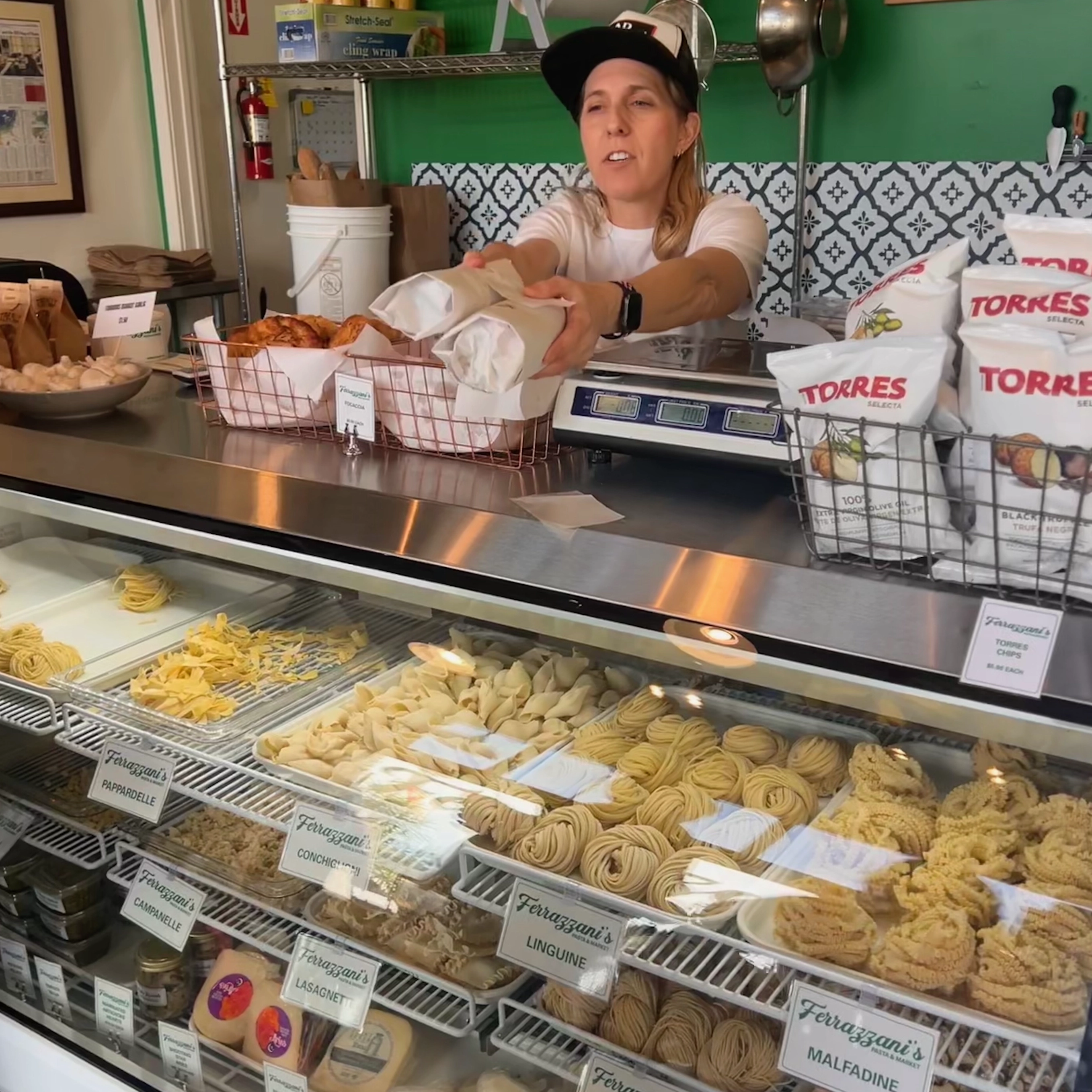 Staff serving at Ferrazzani's fresh pasta deli case in Pasadena
